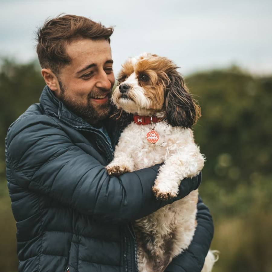 man sitting with dog outside